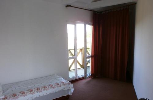 a room with a bed and a large window at Dom Żaglowiec in Olsztyn