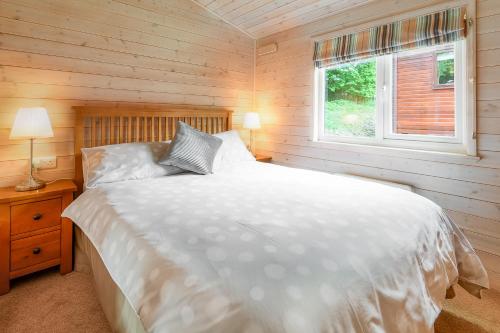 מיטה או מיטות בחדר ב-Woodlands Hotel & Pine Lodges