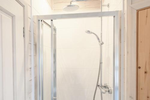 a shower with a glass door in a bathroom at Woodlands Hotel & Pine Lodges in Grange Over Sands