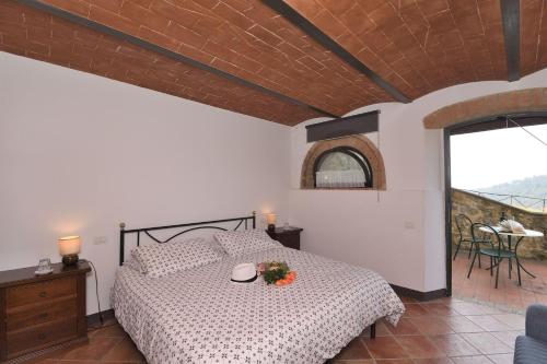 a bedroom with a bed and a balcony at Casale Vecchio Fienile in SantʼAppiano