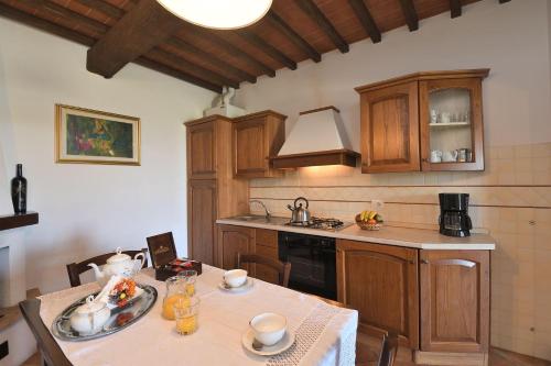 a kitchen with a table and a stove top oven at Casale Vecchio Fienile in SantʼAppiano
