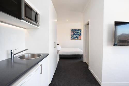 a bathroom with a sink and a toilet in a room at Bay 10 - Suites and Apartments in Port Lincoln