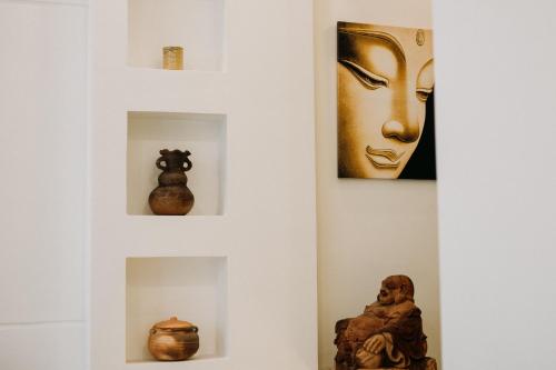 a gallery with vases and art on the walls at Tâm Homestay in Hue