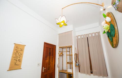 a hallway with a ceiling fan and a door at Tâm Homestay in Hue