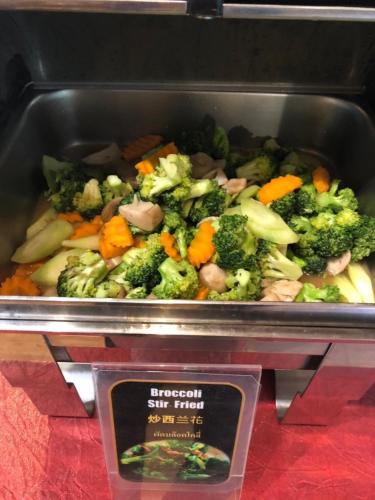 a tray of broccoli and other vegetables on a display at Vieng Mantra Hotel in Chiang Mai