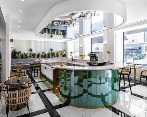 a kitchen with a large island in the middle of a room at Best Western Premier Hotel Roosevelt in Nice