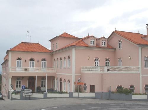 a large pink building with red tile roofs at INATEL Luso in Luso