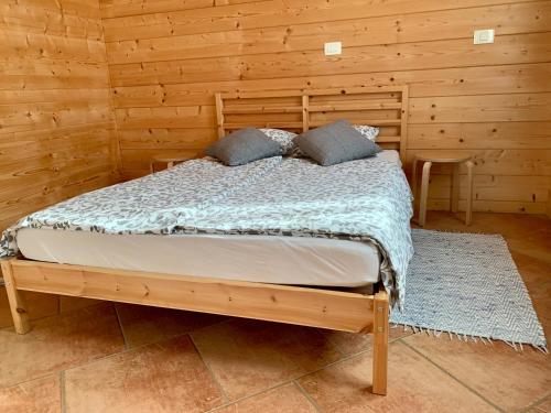 a bedroom with a bed in a log cabin at B&B Woodhouse in Brezje