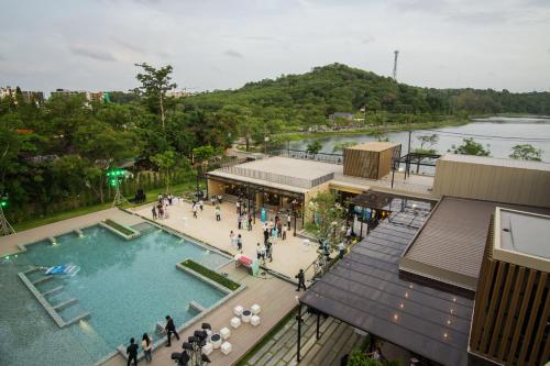 a group of people standing around a swimming pool at The Gallery Hotel Nai Harn in Nai Harn Beach