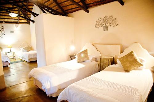 A bed or beds in a room at Lalapanzi Hotel & Conference Centre