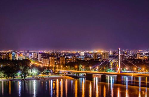 a view of a city at night with a bridge at Piccolo in Novi Sad