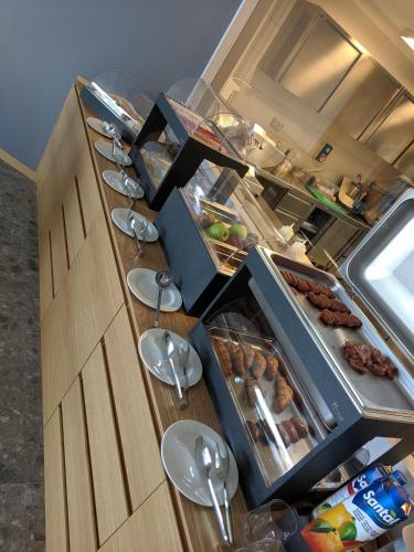 a kitchen with a long buffet with food on it at Buzë Boutique Hotel in Sarandë