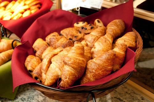 a basket filled with croissants and other pastries at Super Hotel Kofu Showa Inter in Showa