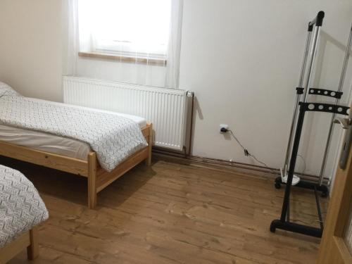 a bedroom with two beds and a window and a tripod at JUDIA in Litomyšl