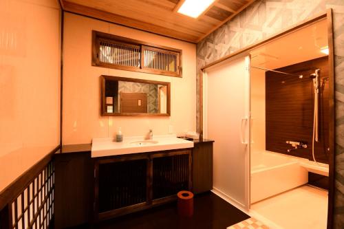 a bathroom with a sink and a shower at Koyasan Shukubo Jokiin in Koyasan