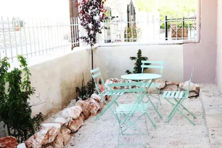 two chairs and a table in a room at luxurious apartments Angelina in Karavomylos