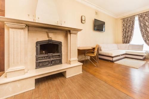 a living room with a fireplace and a couch at GoodRest on Ekaterininskaya in Odesa