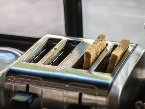 a toaster with two burners in it at Botanic Service Room at Impact Muangthongthani - SHA Certified in Nonthaburi