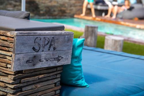 a sign on a ping pong table next to a pool at Windtown Lagoon Hotel in Langebaan