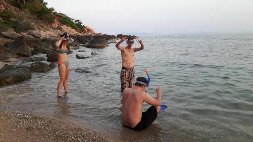 a group of people in the water at the beach at Tao Thong Villa 2 in Ko Tao