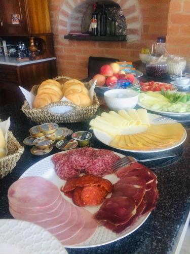 a table full of different types of meats and cheese at Varga Villa in Orfű