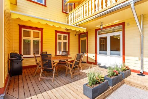 a wooden deck with a table and chairs on a house at Villa Rosalie in Pärnu