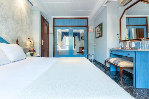 a bedroom with a white bed and a blue desk at Hotel Canadá in Tarragona