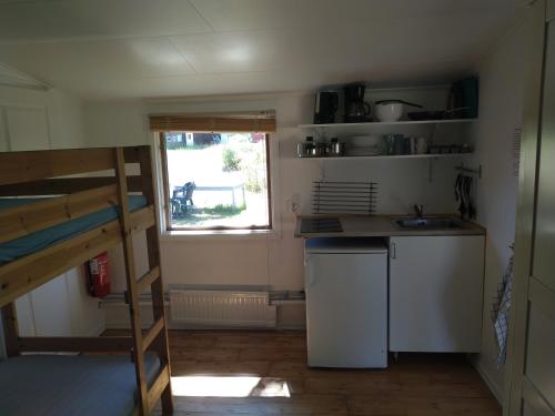 a small kitchen with a sink and a window at Kvarngården Natur Resort in Byxelkrok