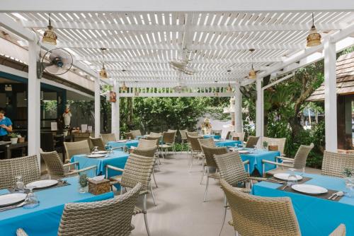 a row of blue tables and chairs on a patio at Aonang Buri Resort in Ao Nang Beach
