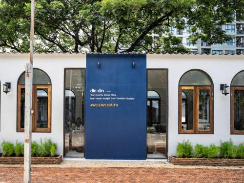 a blue door in front of a building at Botanic Service Room at Impact Muangthongthani - SHA Certified in Nonthaburi