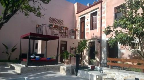 a building with a porch and a balcony at The Manor - Old Town Rethymno, Crete in Rethymno Town