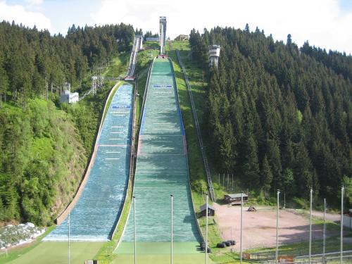 a bridge over a river with a train on it at Cafe & Pension Carmen in Brotterode-Trusetal