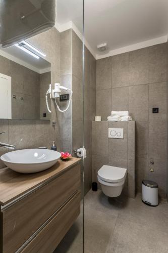 a bathroom with a sink and a toilet at 2NIGHTSTUDIOS in Split