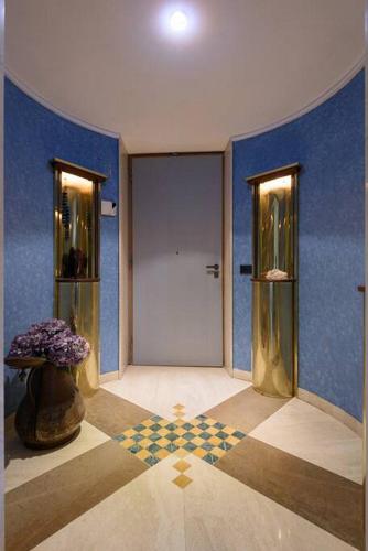 a hallway with a door and a vase with flowers at Penthouse in Siena near Piazza del Campo in Siena