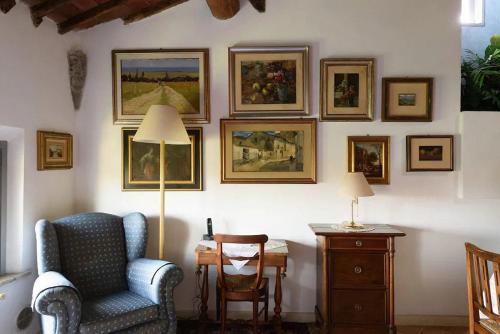 a room with a chair and pictures on the wall at Penthouse in Siena near Piazza del Campo in Siena