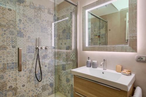 a bathroom with a sink and a shower at One & Only Buonarroti Suite in Rome