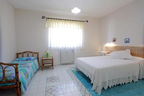a bedroom with two beds and a window at Eremo delle Grazie in Ispica