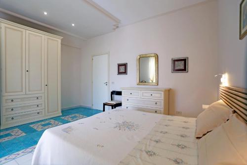 a bedroom with a bed and a dresser and a mirror at Eremo delle Grazie in Ispica