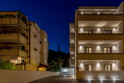 an apartment building at night with two buildings at 2NIGHTSTUDIOS in Split
