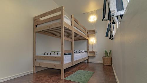 a small room with two bunk beds in it at Cooper in Bangkok