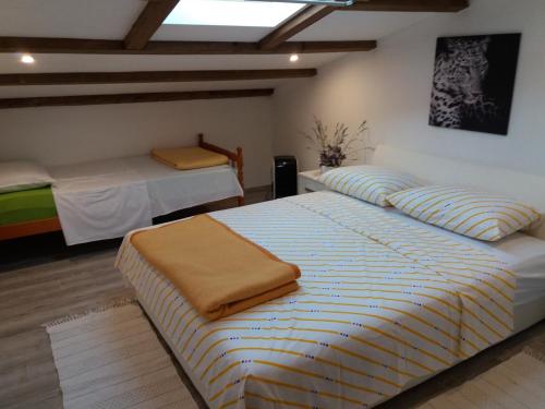 a bedroom with two beds in a room at Apartman Lea in Brodarica