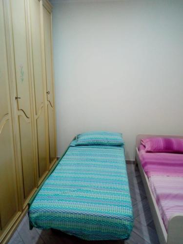 Postel nebo postele na pokoji v ubytování APPARTAMENTO in seminterrato PALMAROLA