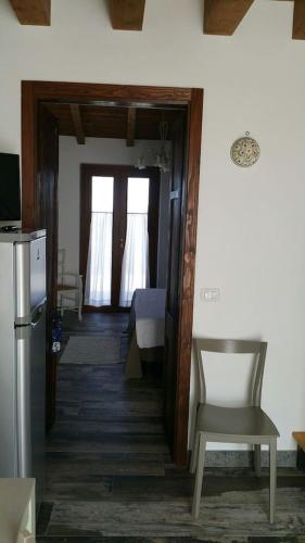 a room with a door and a chair and a table at Casale dei Lamponi a "le Moline" vita in fattoria in Vetralla
