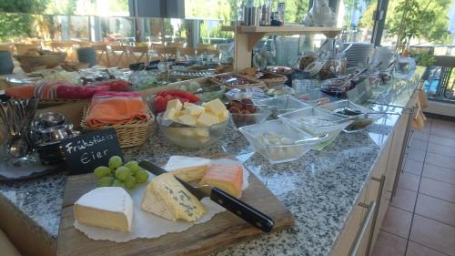a counter top with cheese and other foods on it at Hotel Centgraf in Buergstadt