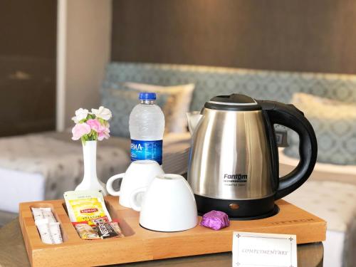 a coffee cup and a tea kettle on a table at Grand Beyazit Hotel in Istanbul