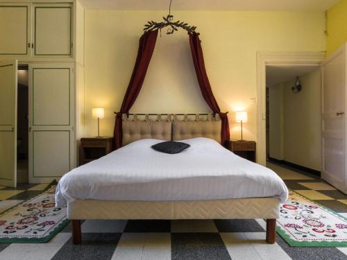 a bedroom with a large bed with a canopy at Heritage Castle in Chaleix with shared pool in Chaleix