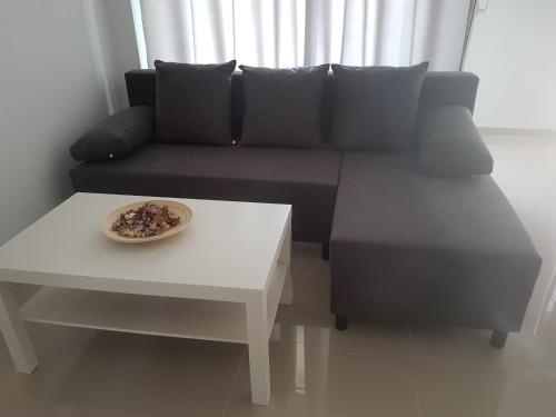 a living room with a couch and a table at Zielone Apartamenty Katowice Chorzów in Chorzów