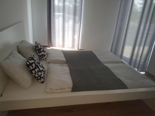 a bed in a room with a window at Zielone Apartamenty Katowice Chorzów in Chorzów