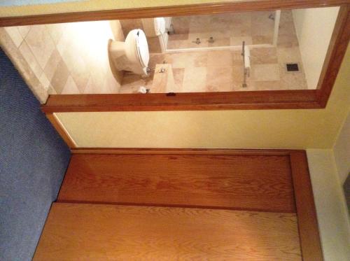 a bathroom with a toilet paper dispenser on the wall at Hotel Sevilla in Mexico City
