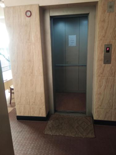 an elevator in an office building with a glass door at COMFORT INN in Nāmakkal